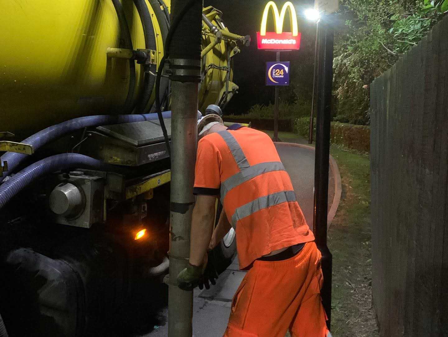 UK Drainage Services engineer working at night